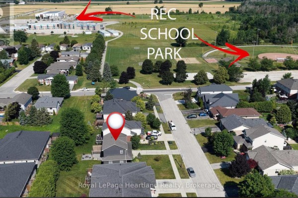 Aerial view of a suburban neighborhood showing houses, roads, a park, and a school. - 770 Scott Street W, North Perth