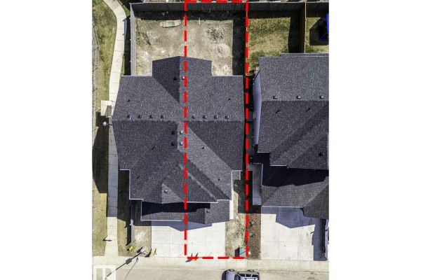 Overhead drone view showing the property lines and layout of the duplex and backyard. - 7709 174a Av Nw, Edmonton
