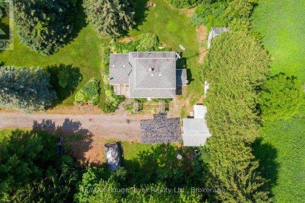 Direct overhead view of the house and outbuildings surrounded by dense green foliage. - 7725 Mill Street, Port Hope