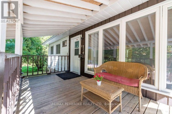 Close-up of a covered porch with wicker furniture and large windows. - 774 Pinegrove Crescent, Petawawa