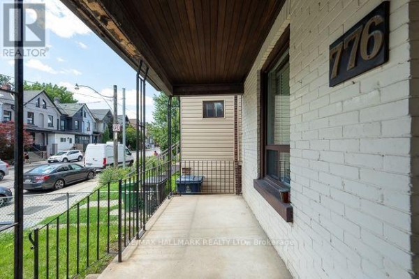View from under the covered porch looking out to the street. - 776 Gerrard Street E, Toronto