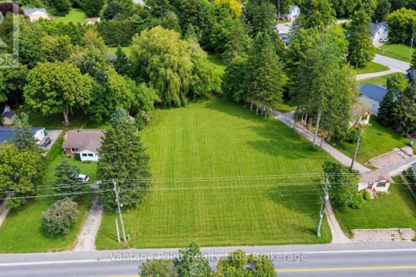 Aerial view of the grassy lot with a small shed and a neighbouring house on the left. - 777011 10 Highway, Chatsworth