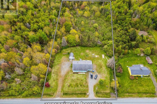 Exterior of the house with white siding, blue trim, and green lawn under a cloudy sky. - 7784 Highway 101, Plympton
