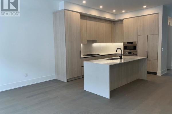 Contemporary kitchen with light wood cabinets, white quartz island, and stainless steel appliances. - 78 - 50 Lou Parsons Way S, Mississauga