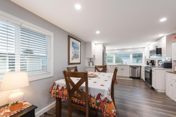 Another angle of kitchen featuring stainless steel fridge, dishwasher, and dark countertops - 78 5742 Unsworth Road, Sardis South, Chilliwack