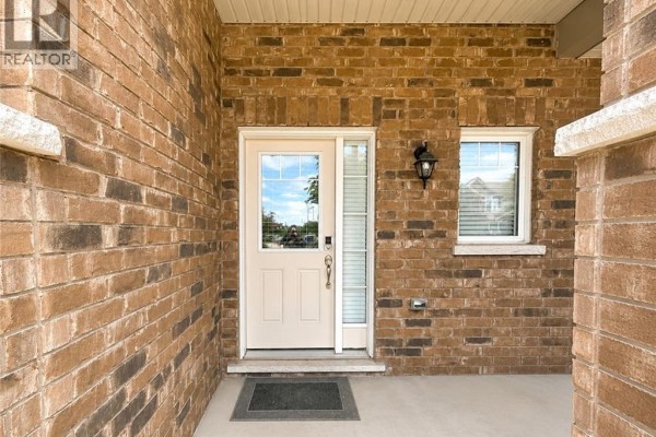 Covered front porch with two black chairs with white piping and a small table. - 78 Glenvista Drive Unit# Upper, Kitchener