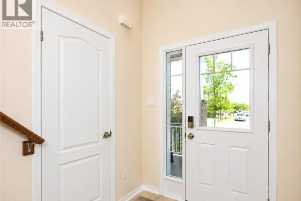 Beige garage door with windows and a brick exterior wall. - 78 Glenvista Drive Unit# Upper, Kitchener