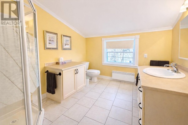 Wooden deck area with stairs and railings, surrounded by trees and open sky. - 78 Irishtown Road, Brigus