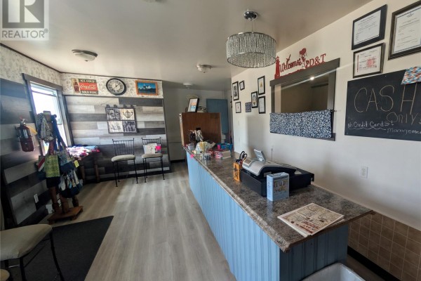 Another interior view of the commercial space with a counter and display. - 78 Main Street, Twillingate
