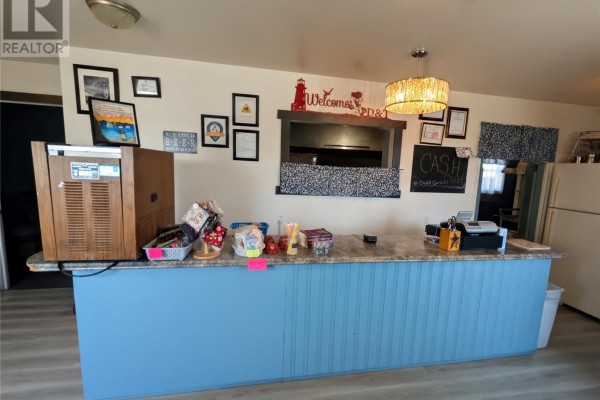 Close-up of the service counter with a cash register and various items. - 78 Main Street, Twillingate