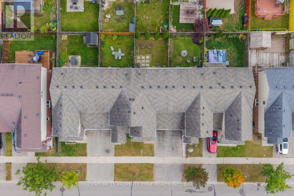 Aerial view of multiple townhouse units with garages and backyards. - 78 Michigan Avenue, Cambridge