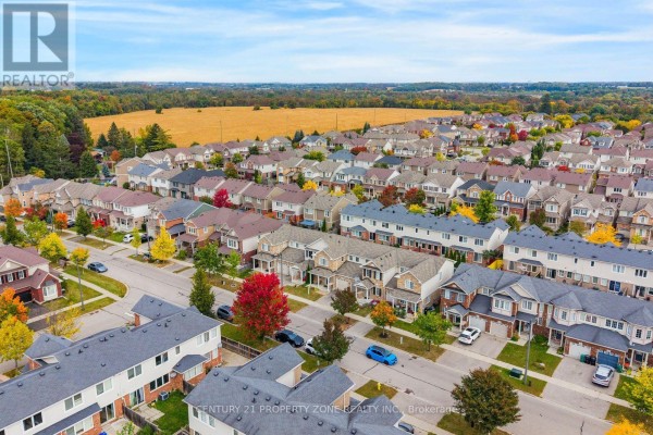 Aerial view of a suburban neighborhood with townhouses, single-family homes, and fall foliage. - 78 Michigan Avenue, Cambridge