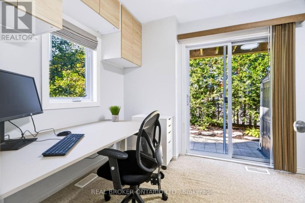 Kitchen with light wood cabinets, granite counters, stainless steel refrigerator, microwave, and coffee machine. - 78 Songbird Private, Ottawa