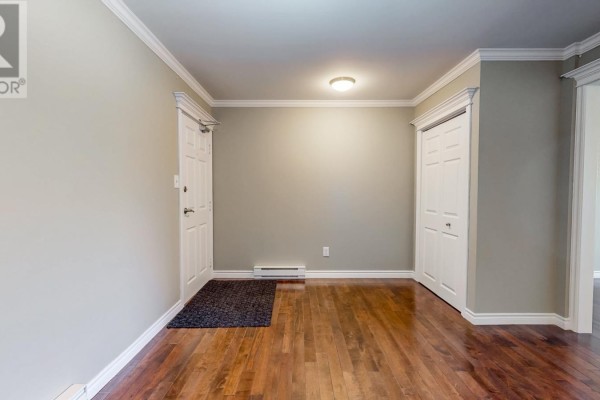 Entryway with hardwood floors, a closet, and a doorway to another room. - 78 Thorburn Road Unit#306, St John S