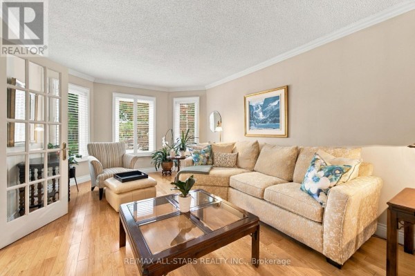 Living room furniture arranged around a bay window with natural light. - 78 Tilman Circle, Markham