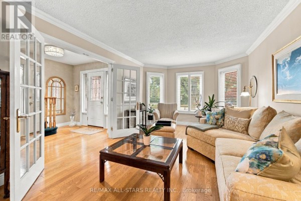 View of the living room and entryway with French doors and hardwood floors. - 78 Tilman Circle, Markham