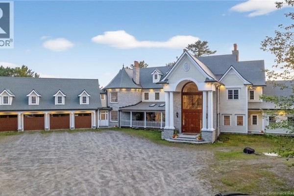 Exterior of a large cream-colored home with a prominent arched entryway and attached multi-bay garage. - 78 Todd's Point Road, Dufferin