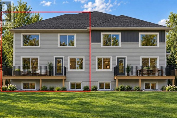 Rear exterior view of a grey duplex showing two back decks and multiple windows. - 78 Waterford Mews, Chestermere