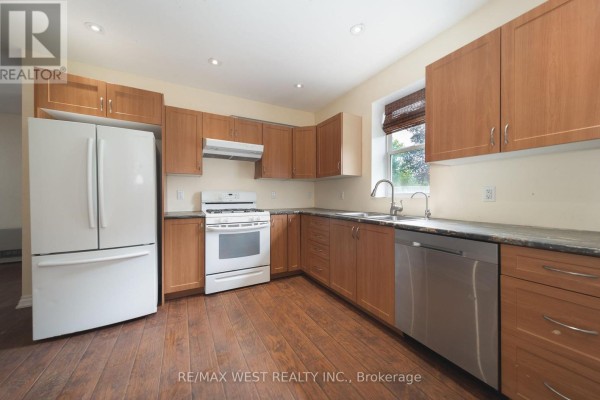 Kitchen with white appliances, wood cabinets, granite counters, and hardwood floors - 7826 Yonge Street Innisfil