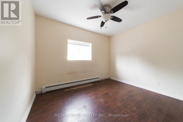 Bedroom with hardwood floors and ceiling fan - 7826 Yonge Street Innisfil
