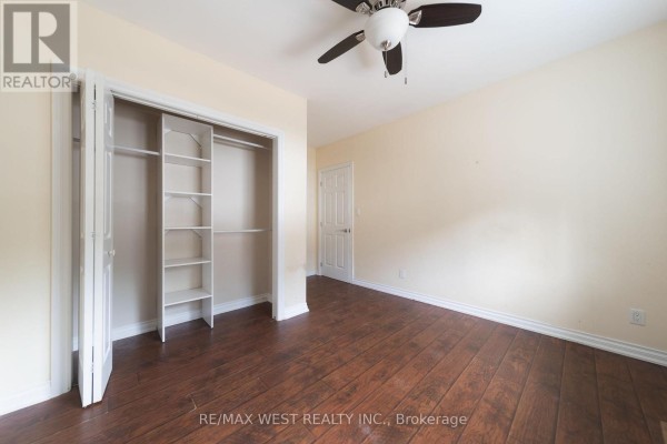 Bedroom with ceiling fan and hardwood floors - 7826 Yonge Street Innisfil