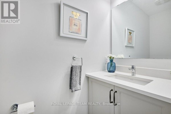 Modern bathroom vanity with quartz countertop, under-mount sink, and artwork - 784 Cappamore Drive Ottawa