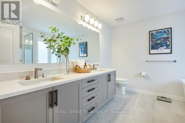 Modern double vanity with quartz countertops and artwork - 784 Cappamore Drive Ottawa