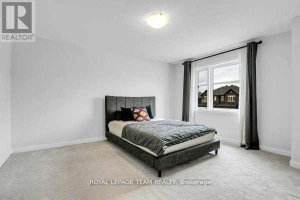 King size bed with grey headboard and textured bedding - 784 Cappamore Drive Ottawa