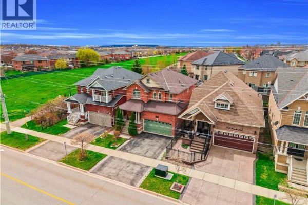 Aerial view of residential street lined with brick houses and driveways. - 786 Fourth Line, Milton