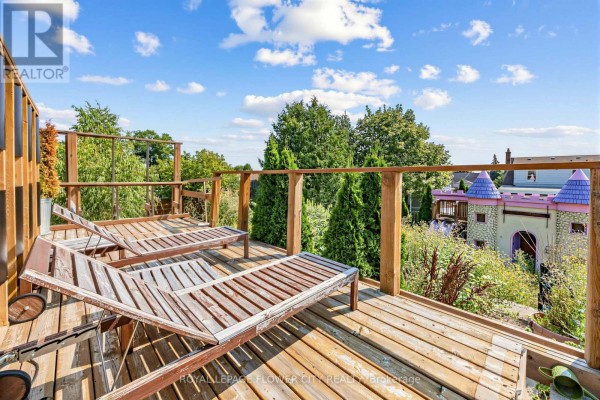 Wooden deck with lounge chairs and castle playhouse view - 79 Kimberly Drive Hamilton