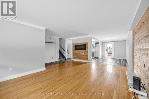 Living room with fireplace and wood accent wall - 79 Kimberly Drive Hamilton