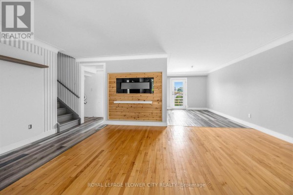 Living room with wood accent wall and mounted TV - 79 Kimberly Drive Hamilton
