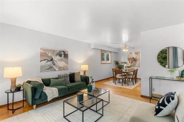 Living and dining room area with light walls, wood floors, and large windows. - 79 Mattinee Bay, Winnipeg
