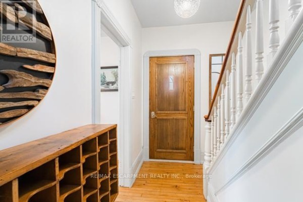 Dining room featuring a table, chairs, and a large antique hutch, with natural light from windows. - 79 Mcmurray Street, Bracebridge