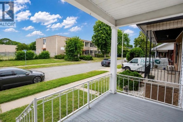 View from front porch overlooking street with cars and apartment buildings. - 790 Marentette, Windsor