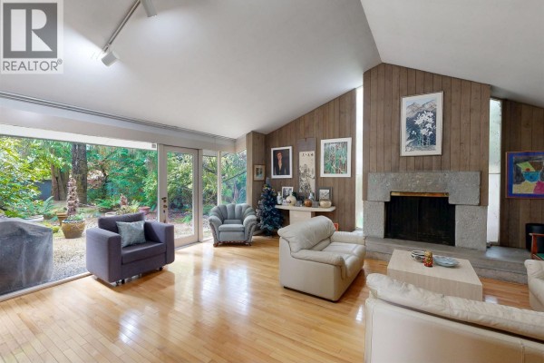 Entrance hallway with slate tile floor and wood paneled walls displaying framed artwork. - 792 W 54th Avenue, Vancouver