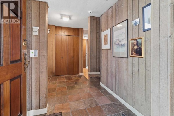 Kitchen with wood cabinets, slate tile floor, and a stainless steel range. - 792 W 54th Avenue, Vancouver