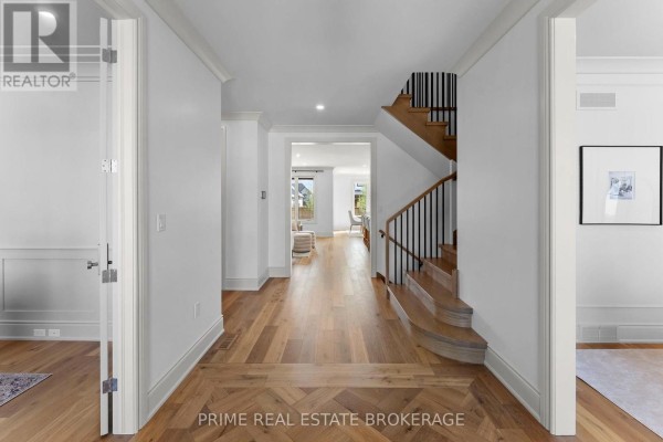Carpeted staircase with light wood treads and dark metal spindles, leading upwards. - 793 Valleystream Walk, London North