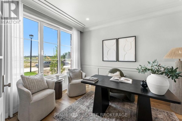Open-concept kitchen with a large island, stainless steel dishwasher, white cabinetry, and dining area. - 793 Valleystream Walk, London North