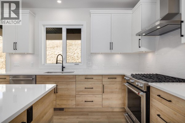 Open kitchen layout with pendant lighting and sliding barn door - 796 Kuipers Crescent Unit# 27, Kelowna