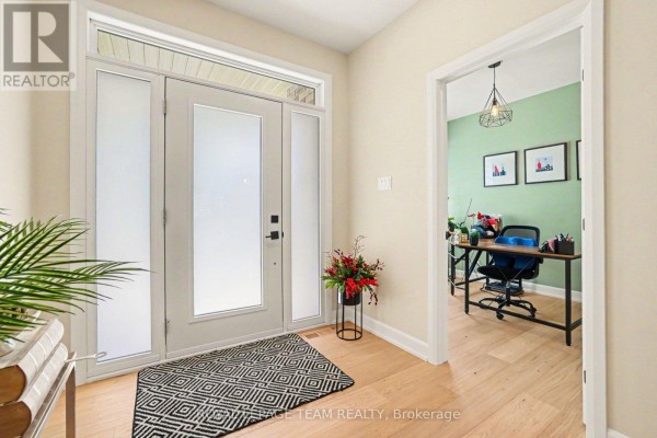 Foyer with view into a green-walled office with a desk and chairs. - 7a King Street N, Ottawa