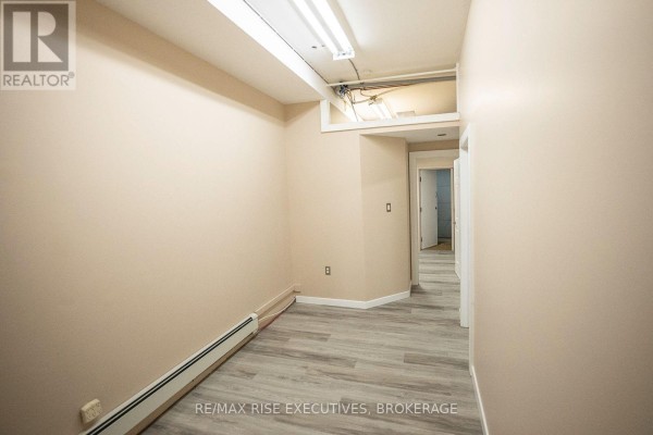Interior of garage with sectional door, washer, dryer, and shelving. - 8 - 637 Norris Court, Kingston