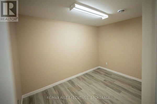 Small washroom with toilet, sink, and standing shower stall. - 8 - 637 Norris Court, Kingston