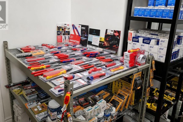Stack of cardboard boxes and materials next to bins of plumbing supplies. - 8 - 7040 Torbram Road, Mississauga