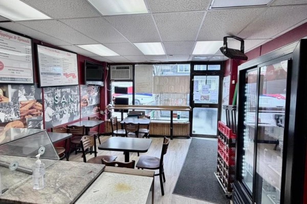 View from inside the sandwich shop looking towards the entrance and street with seating areas. - 8-10 Clinton Street, Toronto