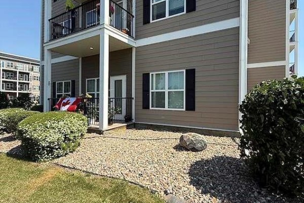 Apartment building exterior with a balcony and Canadian flag displayed. - 8 1802 106th Street, North Battleford