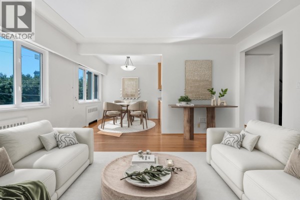 Empty bedroom with polished hardwood floors and a small window letting in natural light. - 8 2296 W 39th Avenue, Vancouver