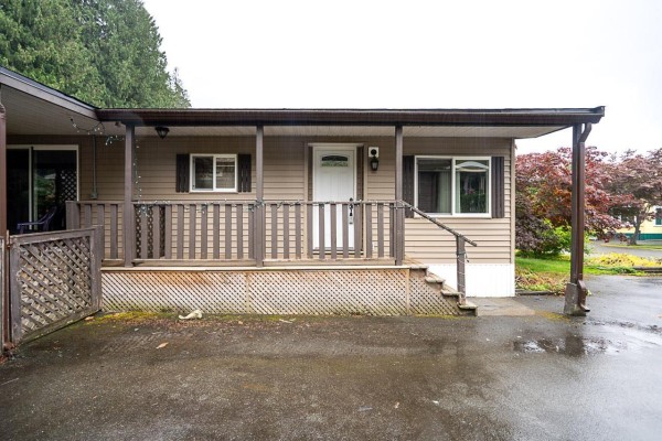 Close-up of mobile home entrance with steps, railing, and white door. - 8 52324 Yale Road, Popkum, Rosedale