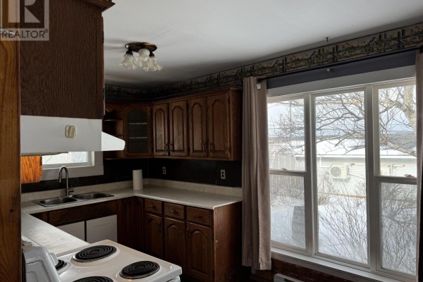 Interior room with wooden ceiling, blue walls, and large window. - 8 Allan J Memorial Avenue, Inverness