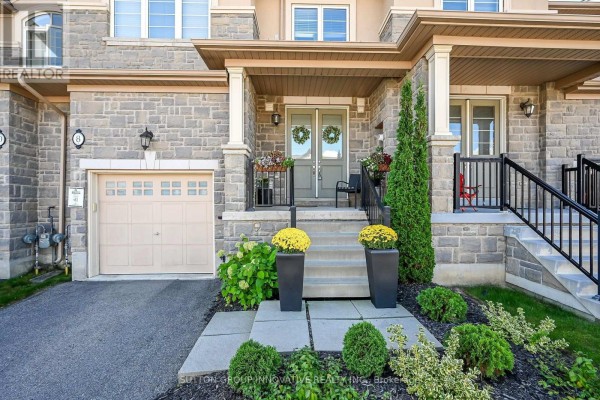 Front entrance with stone facade, garage, walkway, and landscaping. - 8 Callon Drive, Hamilton